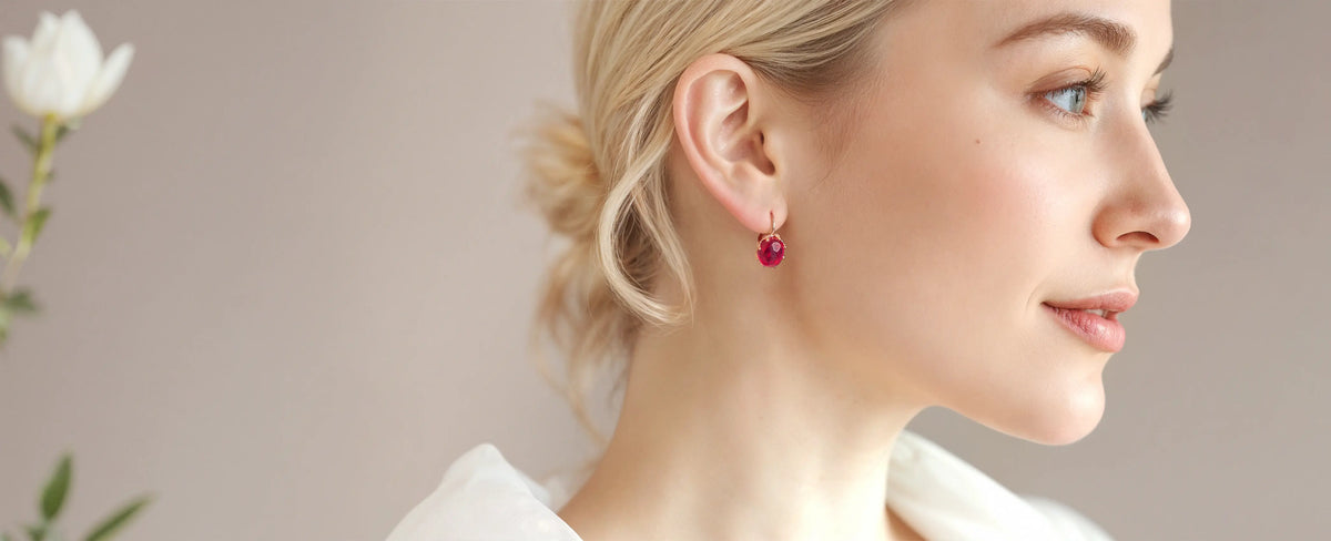 Red ruby earrings on a woman ears