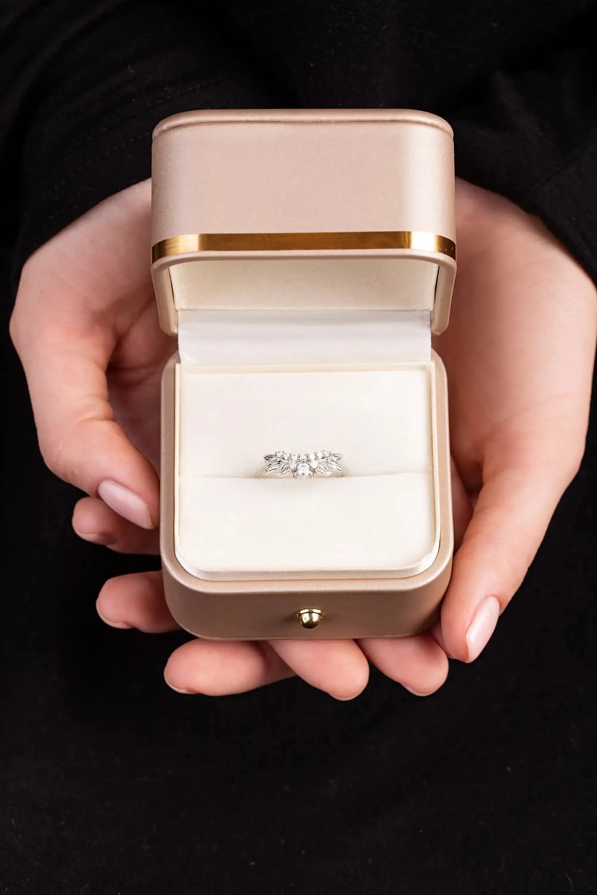 White gold ring with moissanite twig in a gold box