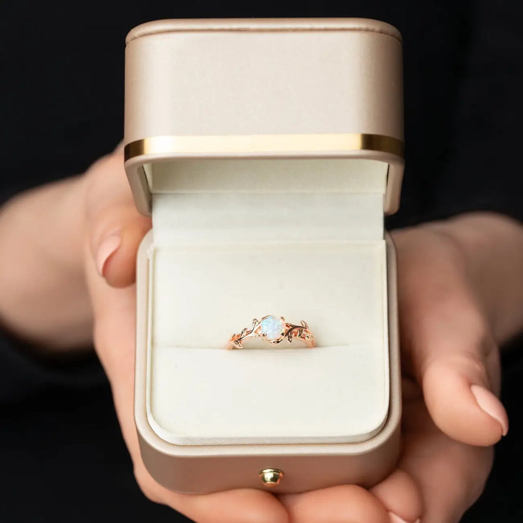 Twig ring with opal in a golden box