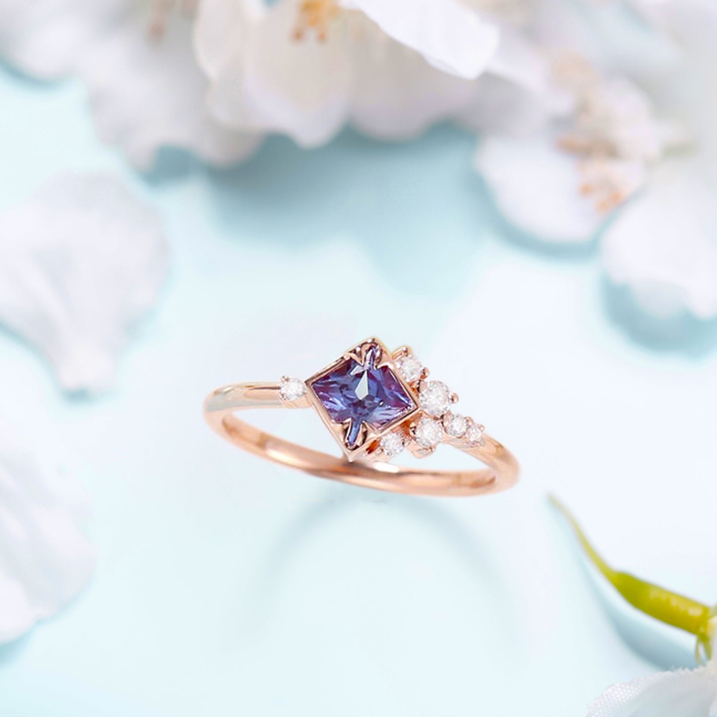 Zircon ring with a violet alexandrite stone with flowers on a background