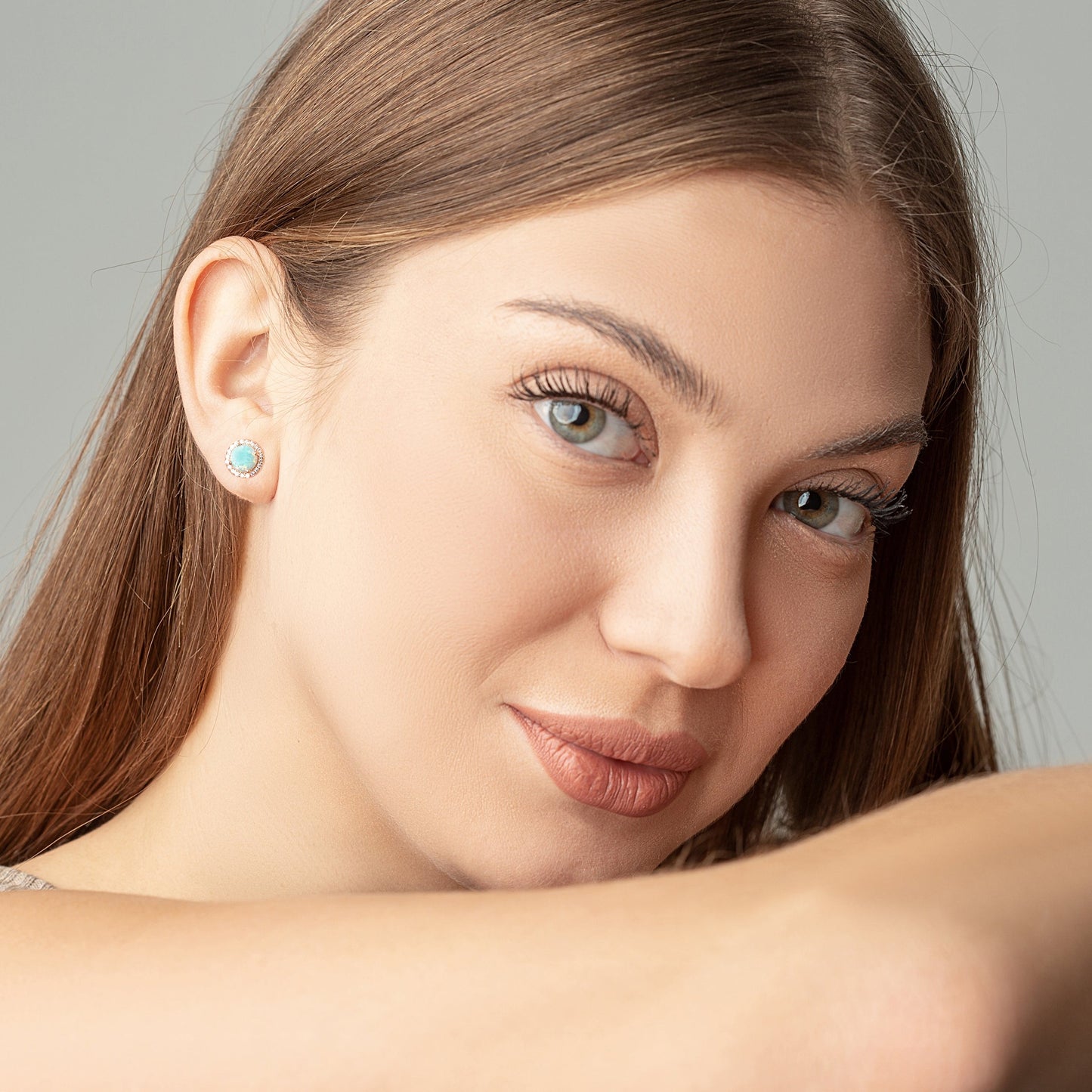 Green Opal Round studs on a woman ears