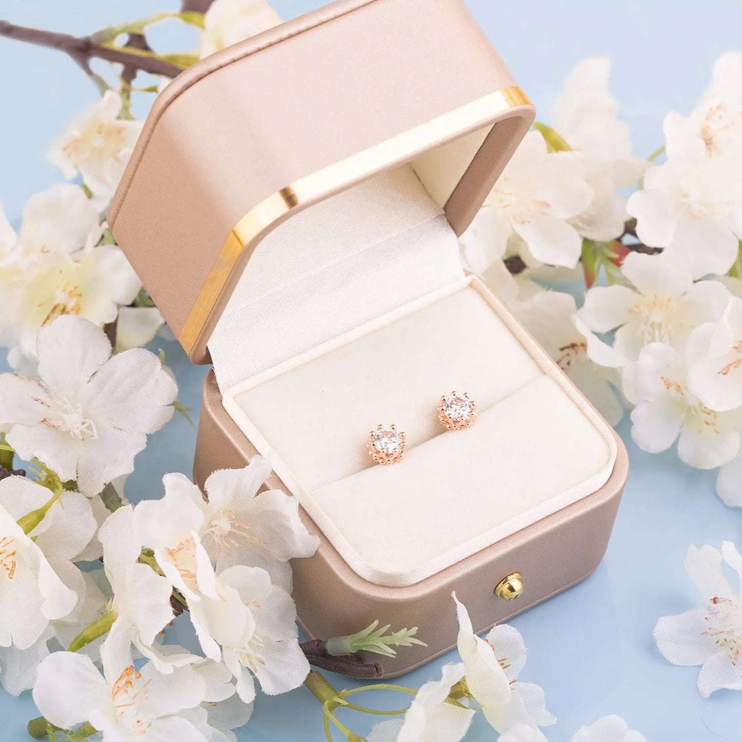Two Moissanite crown studs in a gift box