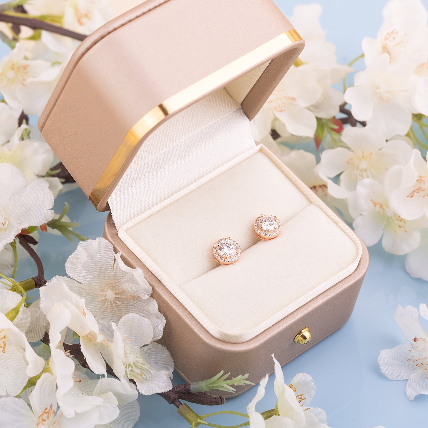 Two Moissanite round studs in a gift box