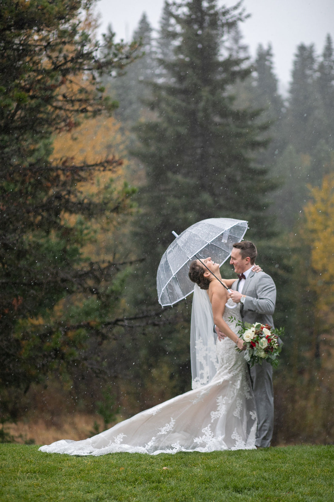 Bride and groom under umbrella 