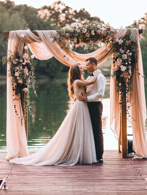 Bride and groom in front of the arch