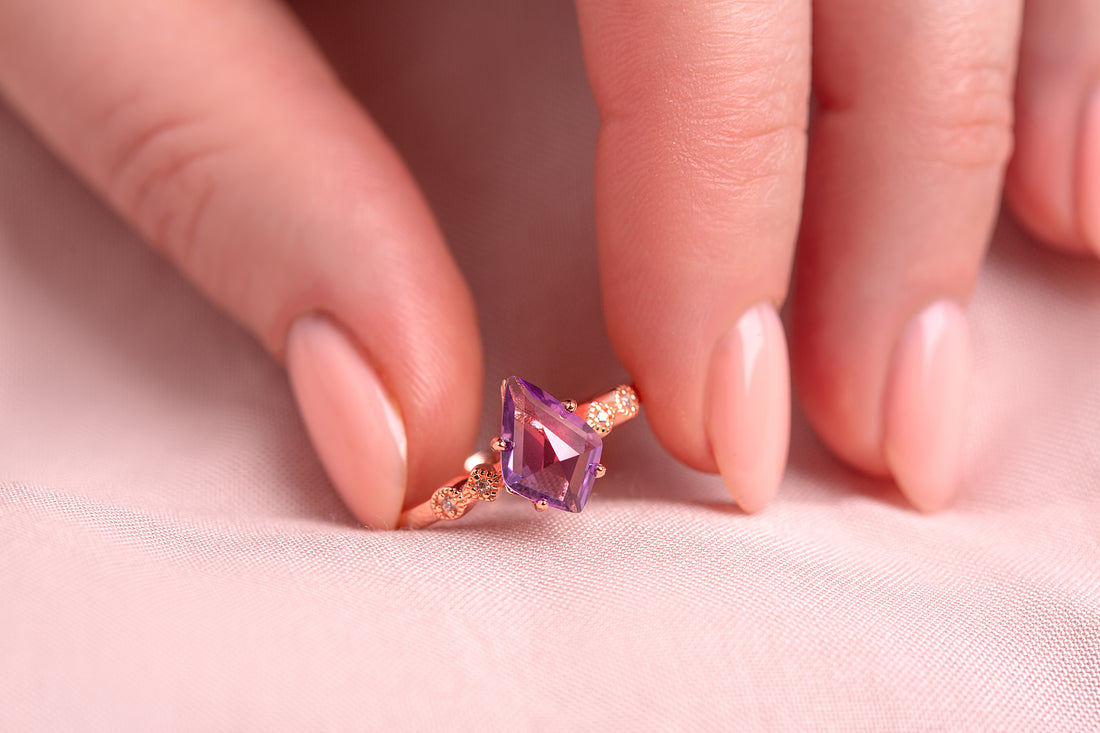 Ring with amethyst stone in a woman hand