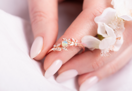Ring with opal stone in a woman hand