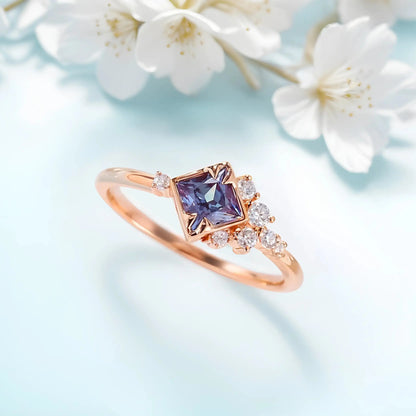 Zircon ring with a violet alexandrite stone with flowers on a background