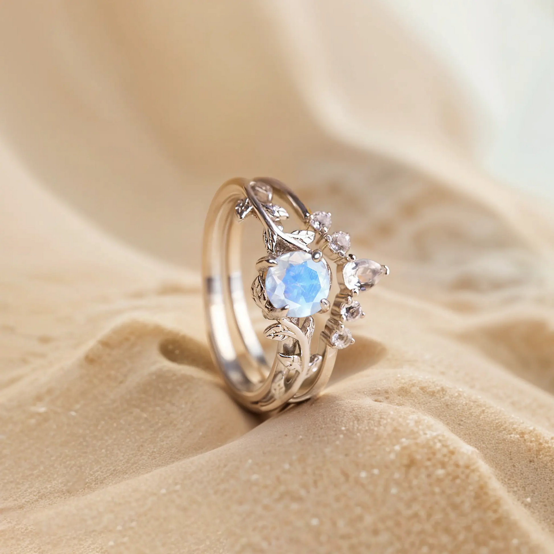 White Gold nature-inspired ring set with moonstone and topaz gemstones, featuring a twigs and leaf design for engagement or wedding rings.