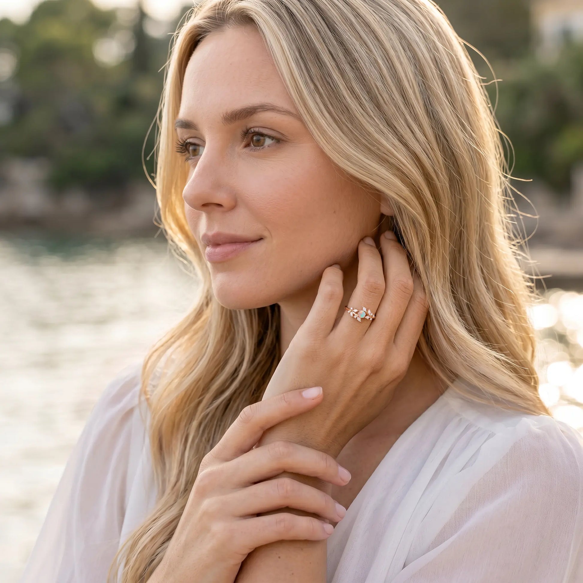 Woman adjusting earring with a scenic background
