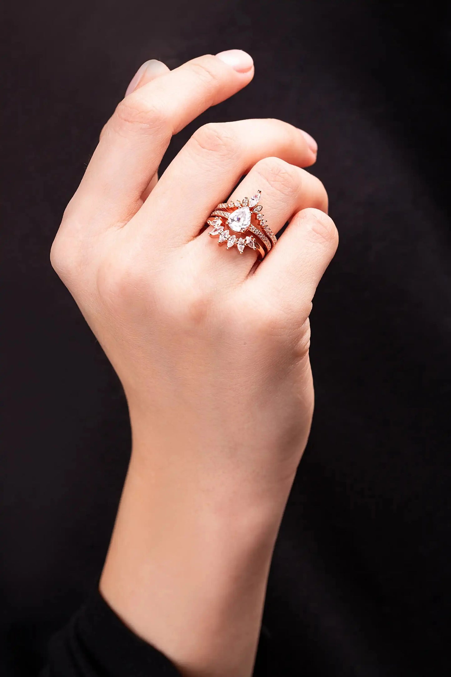 Yellow Gold Ring set for a women with white topaz gemstones. Woman put ring on her finger