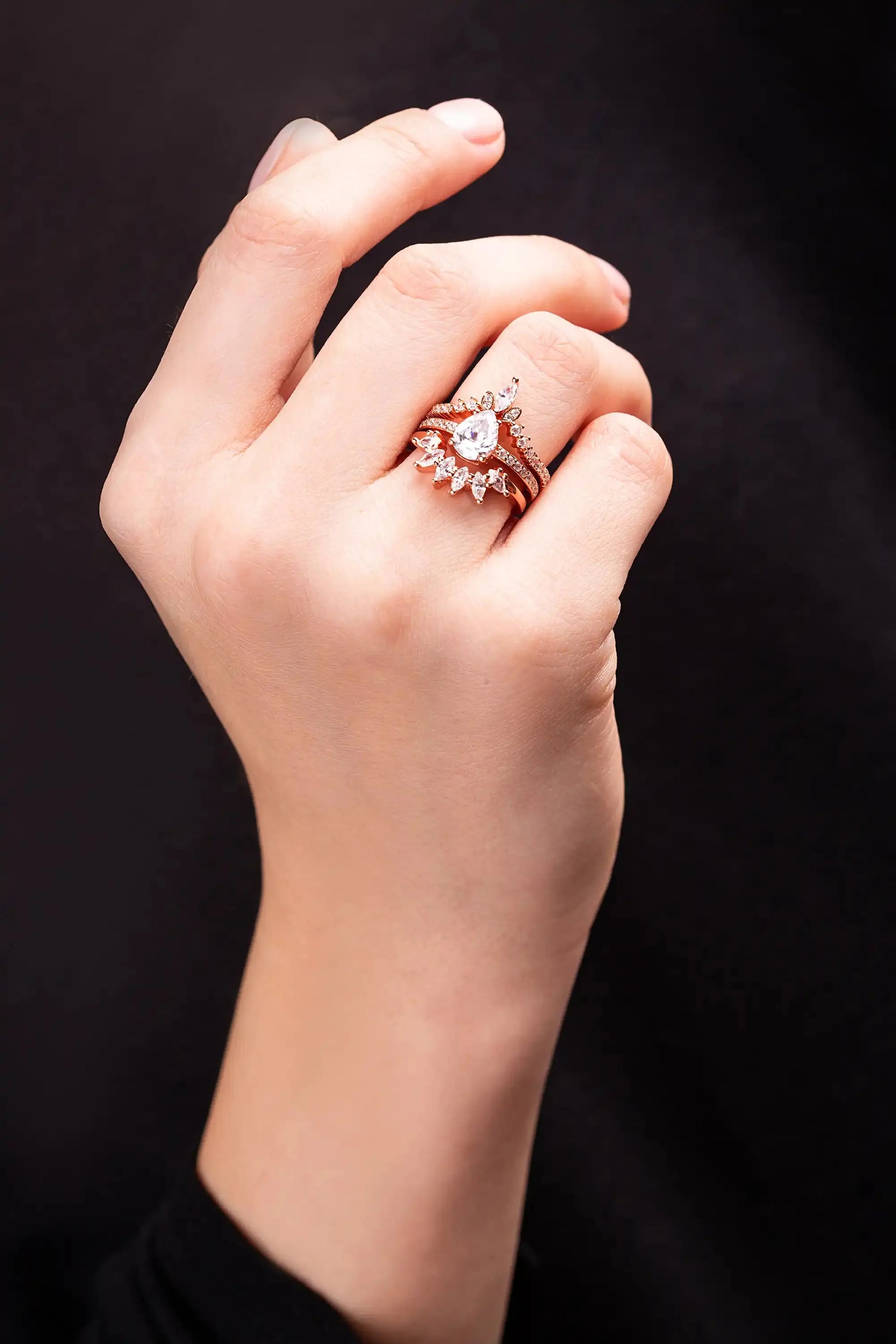 Yellow Gold Ring set for a women with white topaz gemstones. Woman put ring on her finger