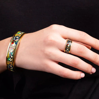 Yellow gold bracelet and yellow gold ring with a painting of Pablo Picasso "Girl in front of the mirror" in a center. Jewelry is on a woman's hands