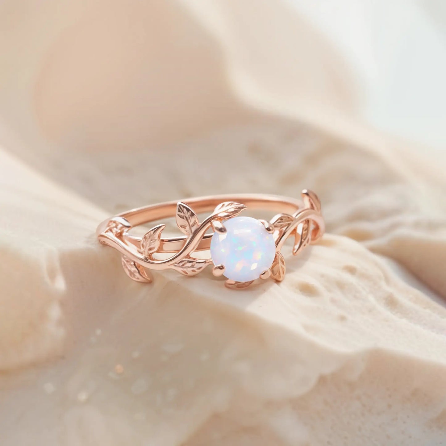 Unique twig ring featuring a shimmering opal gemstone, crafted in a nature-inspired design, perfect as an engagement or promise ring.