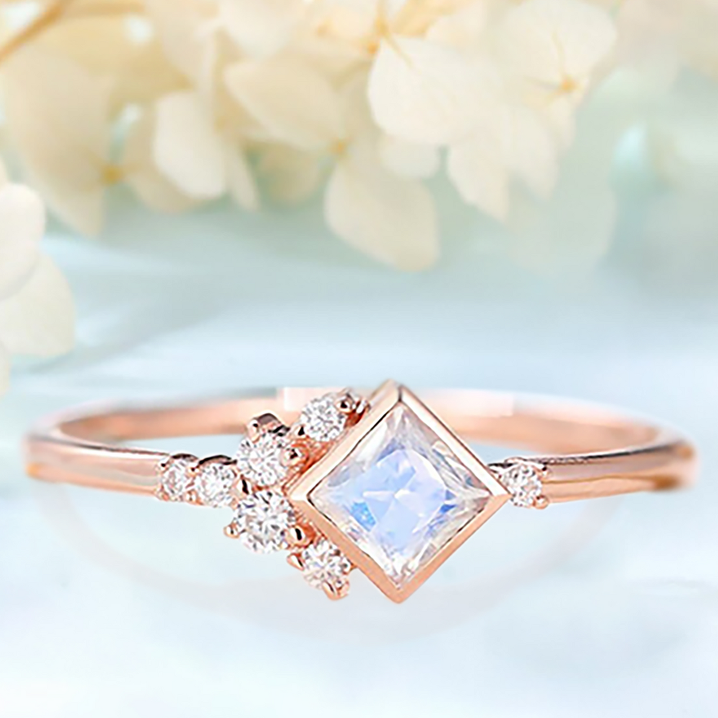 Engagement ring with a Moonstone and white Zircon