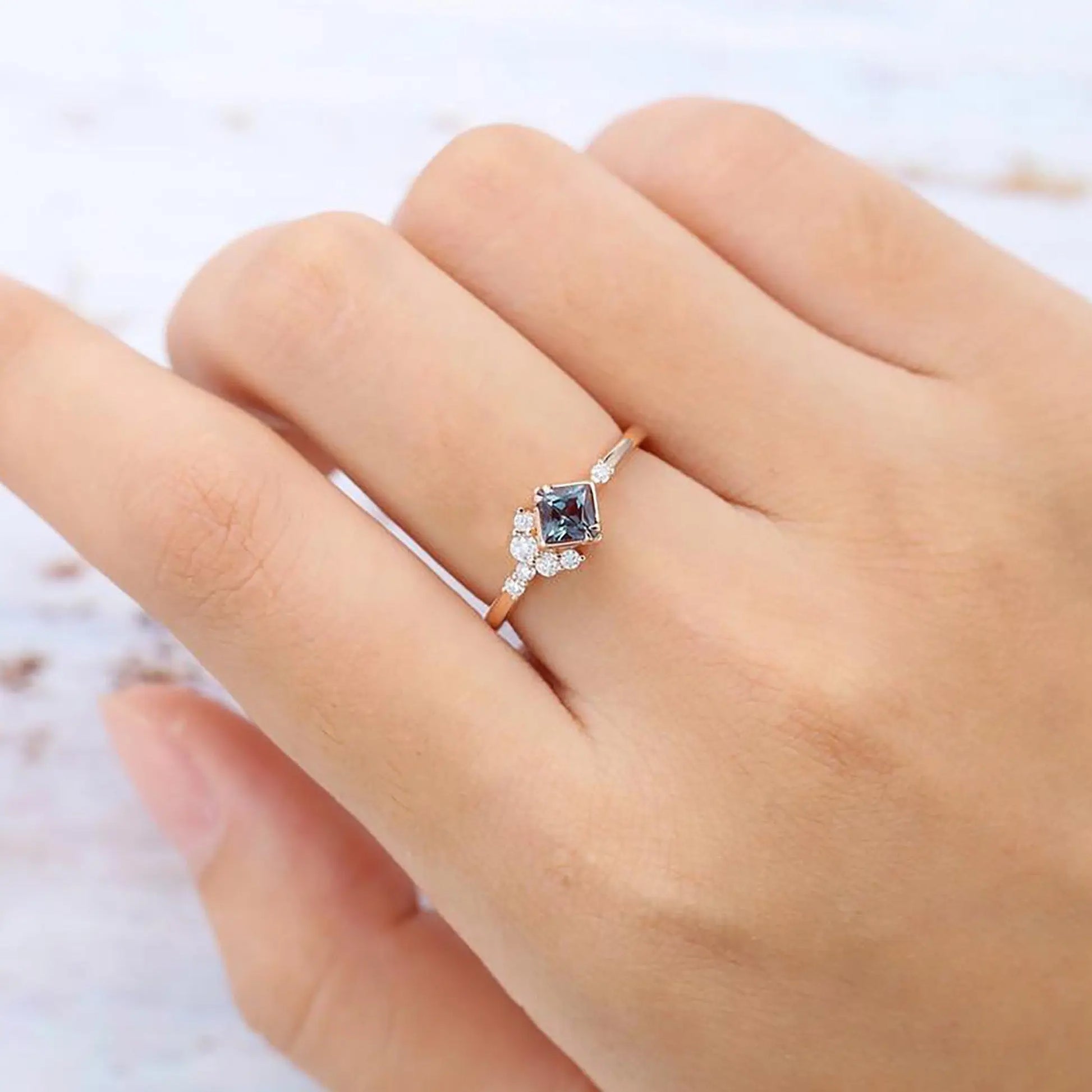 Zircon ring with a violet alexandrite stone on a woman hand