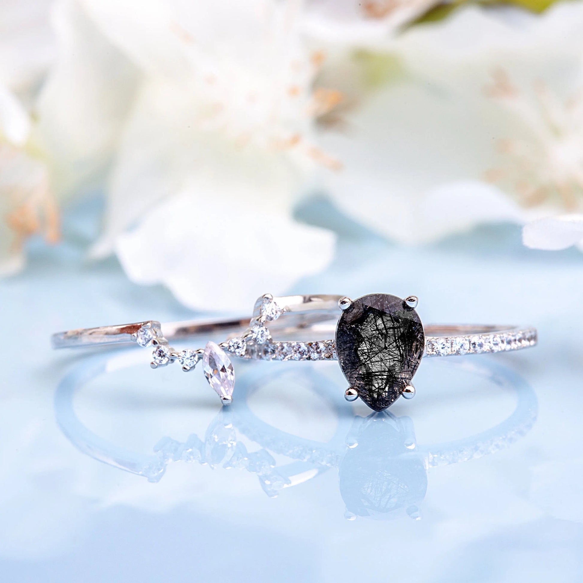 Black Rutilated Quartz, White Topaz and White Zircon rings set