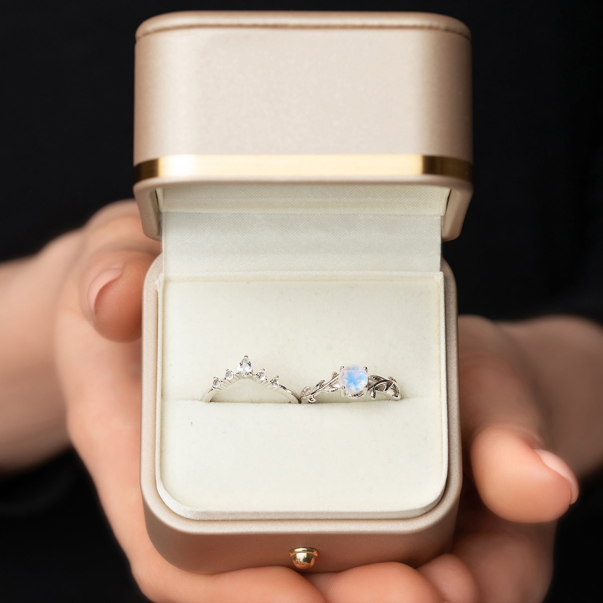 Two rings in a twig form with a Moonstone as the main stone and White Topaz as side stones in a gift box