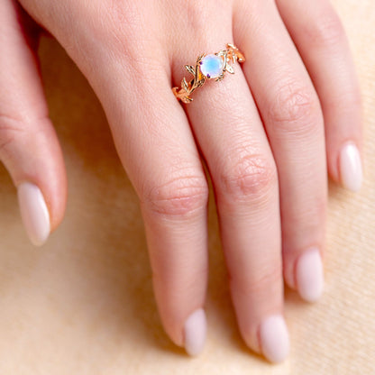 Ring with a moonstone in a twig form on a woman hand