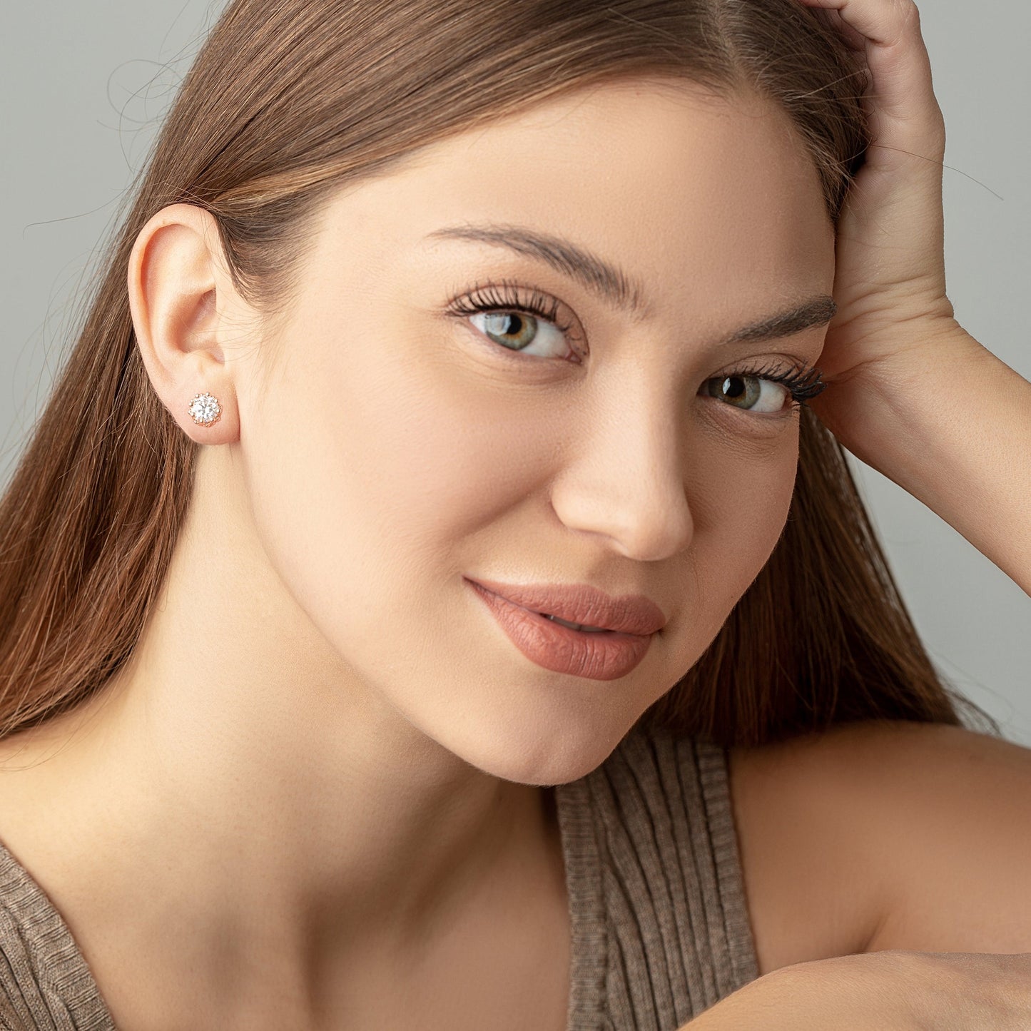 Two Moissanite crown studs on a woman ears
