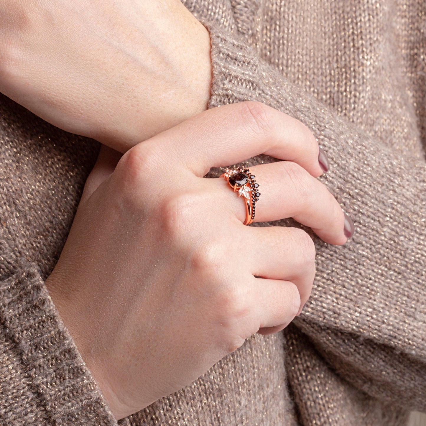 Two rings with a Black Rutilated Quartz as the main stone, White Topaz and Black Spinels on a woman hand