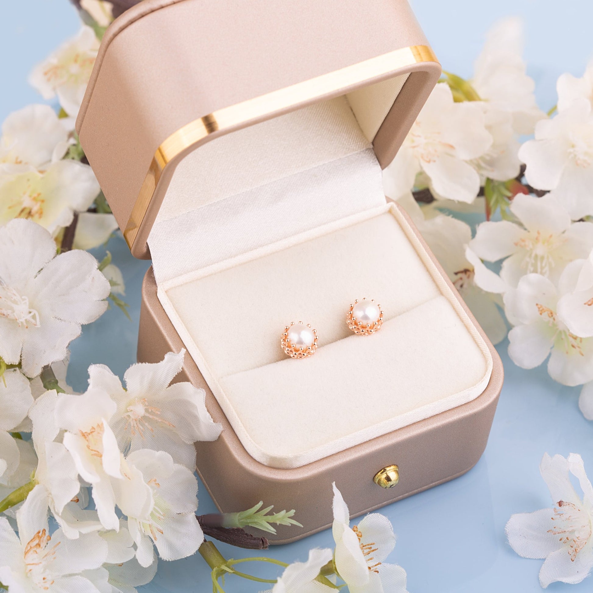 Two Pearl crown studs in a gift box