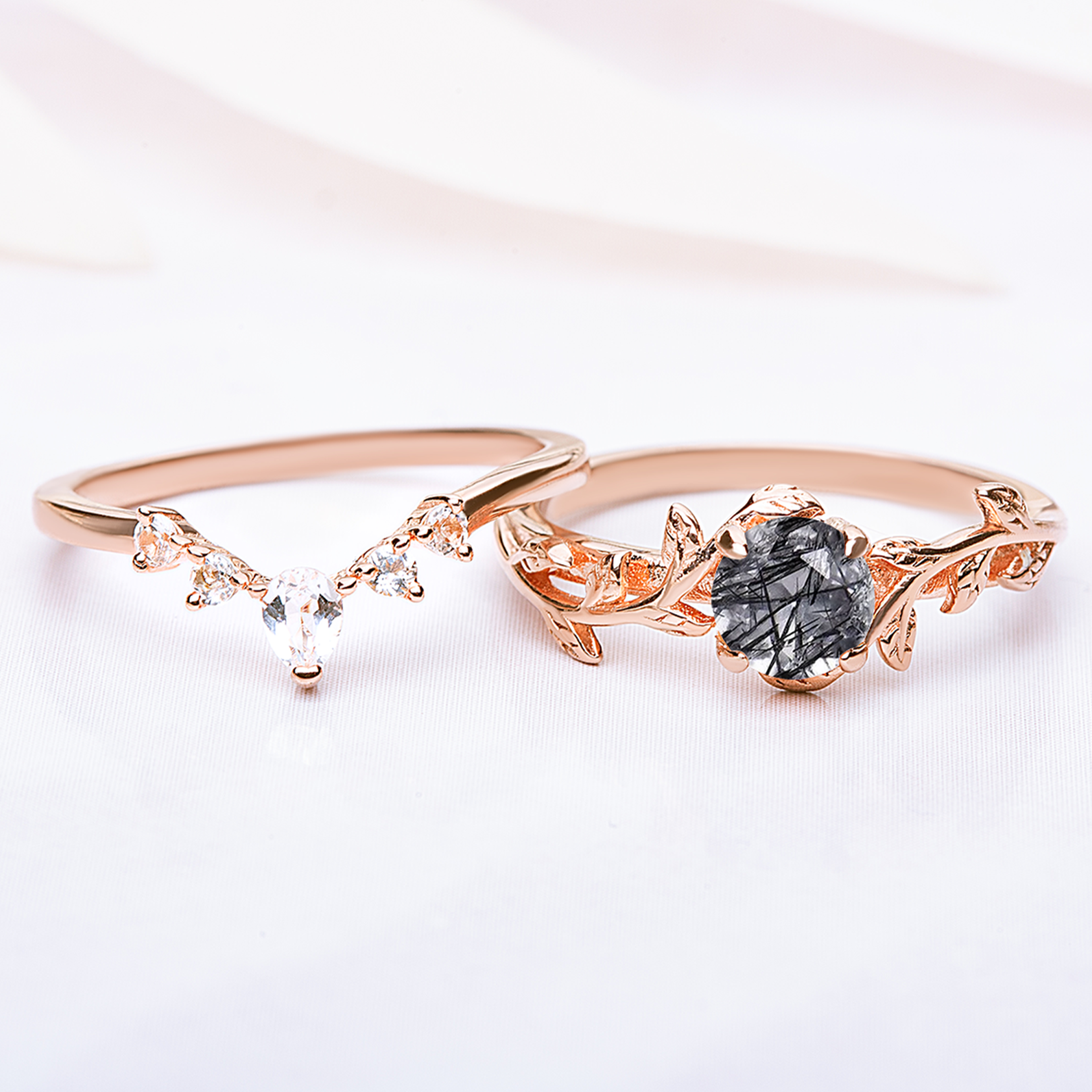 Ring set for women. One ring in a shape of twig with black quartz gemstone, another rings is in a v-shape with zircon gemstones. Rings are gold plated