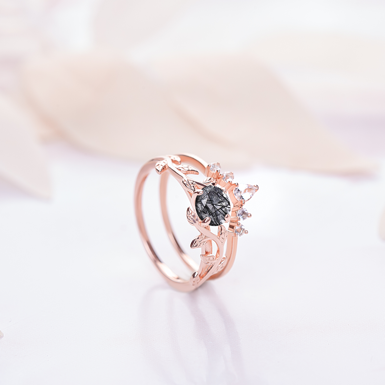 Ring set for women. One ring in a shape of twig with black quartz gemstone, another rings is in a v-shape with zircon gemstones. Rings are gold plated