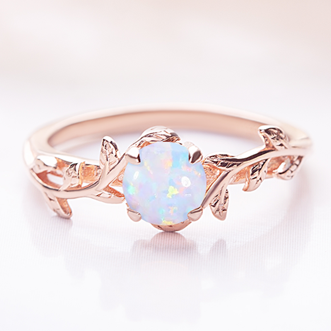 Unique twig ring featuring a shimmering opal gemstone, crafted in a nature-inspired design, perfect as an engagement or promise ring.