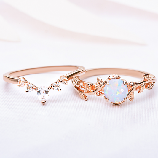 Nature-inspired Twigs Ring Set featuring opal and topaz gemstones with a delicate leaf design, perfect for engagements or weddings.